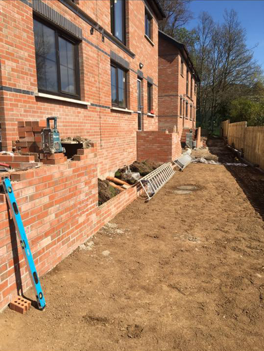 Garden that has been dug up and leveled ready for paving stones