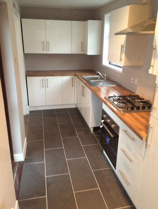 Newly installed white gloss kitchen with wooden counter tops